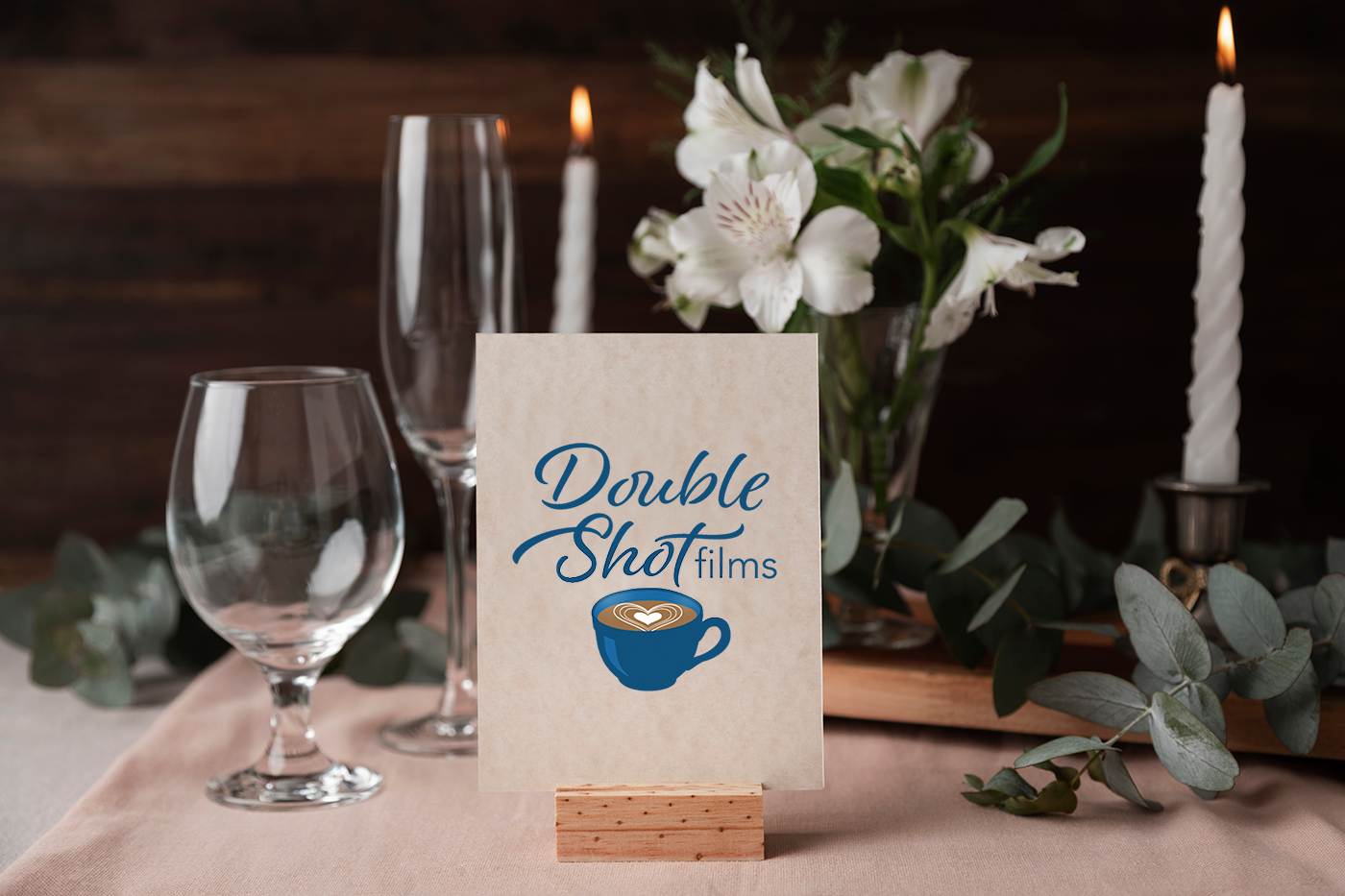 Wedding table with a sign of the Double Shot Films logo